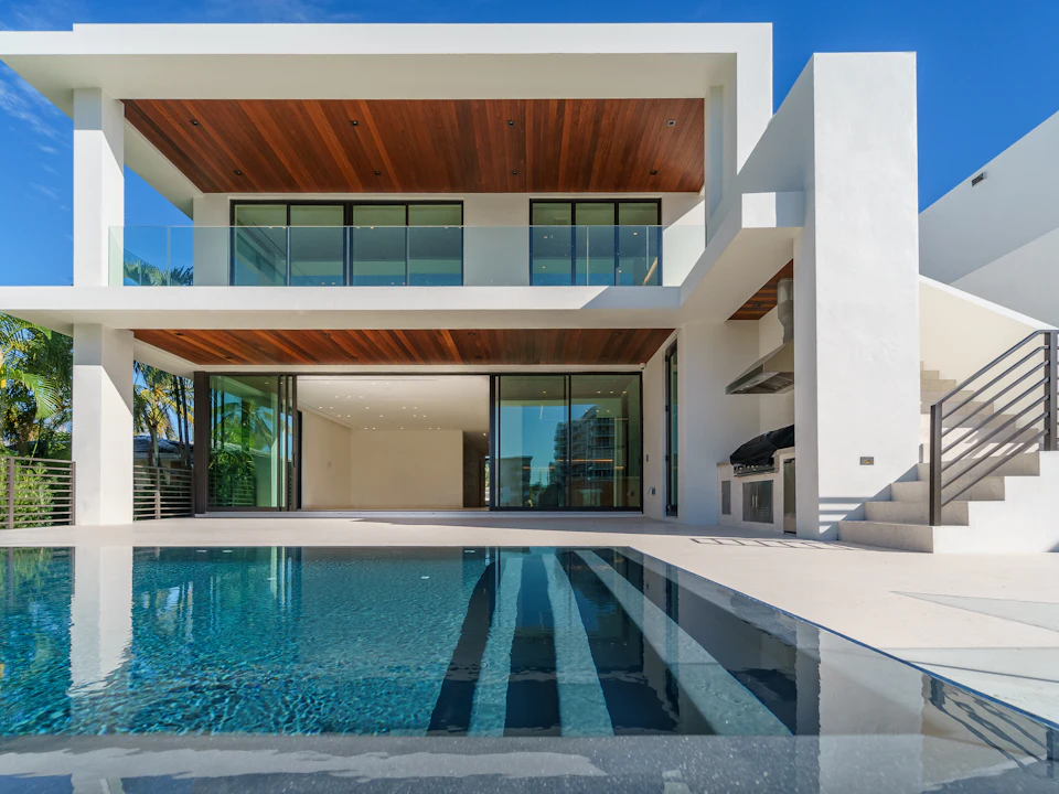 A whitewashed Spanish villa with a private pool in the afternoon sun